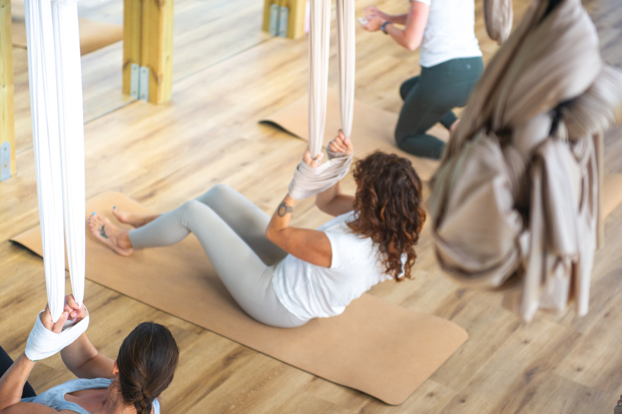 Stretching during an aerial yoga class in Algarve